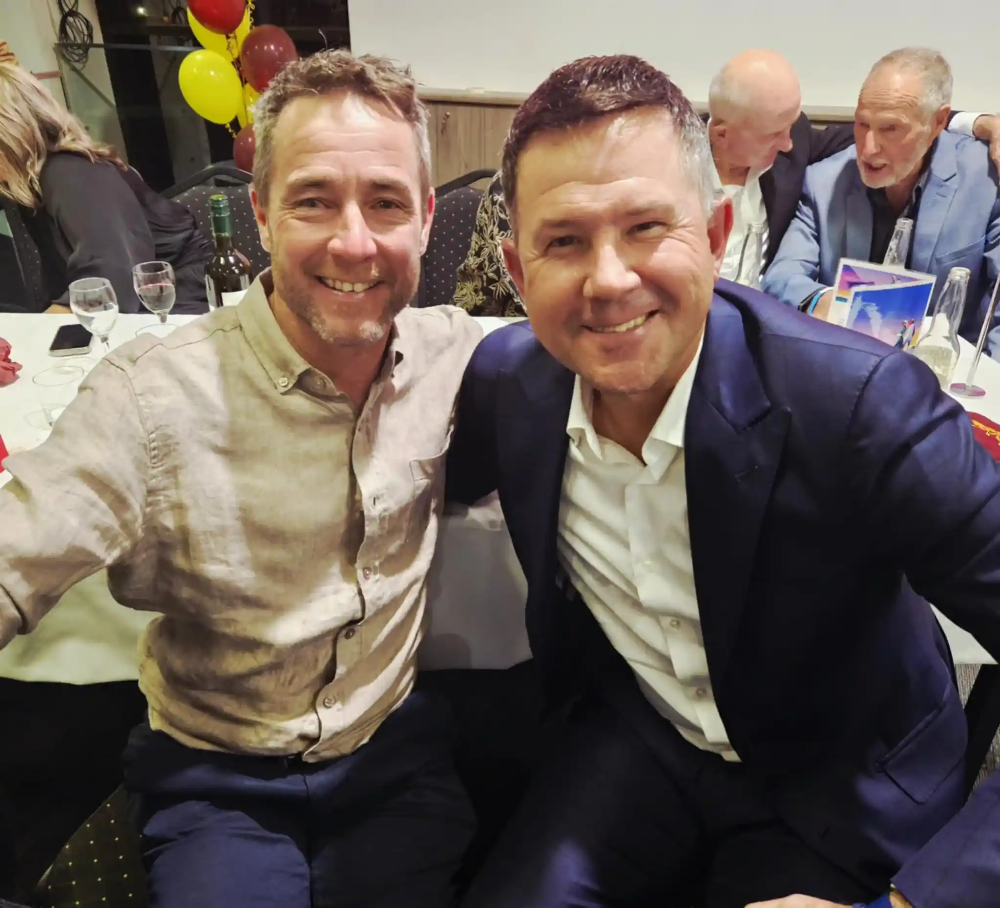 Two men smiling at an event