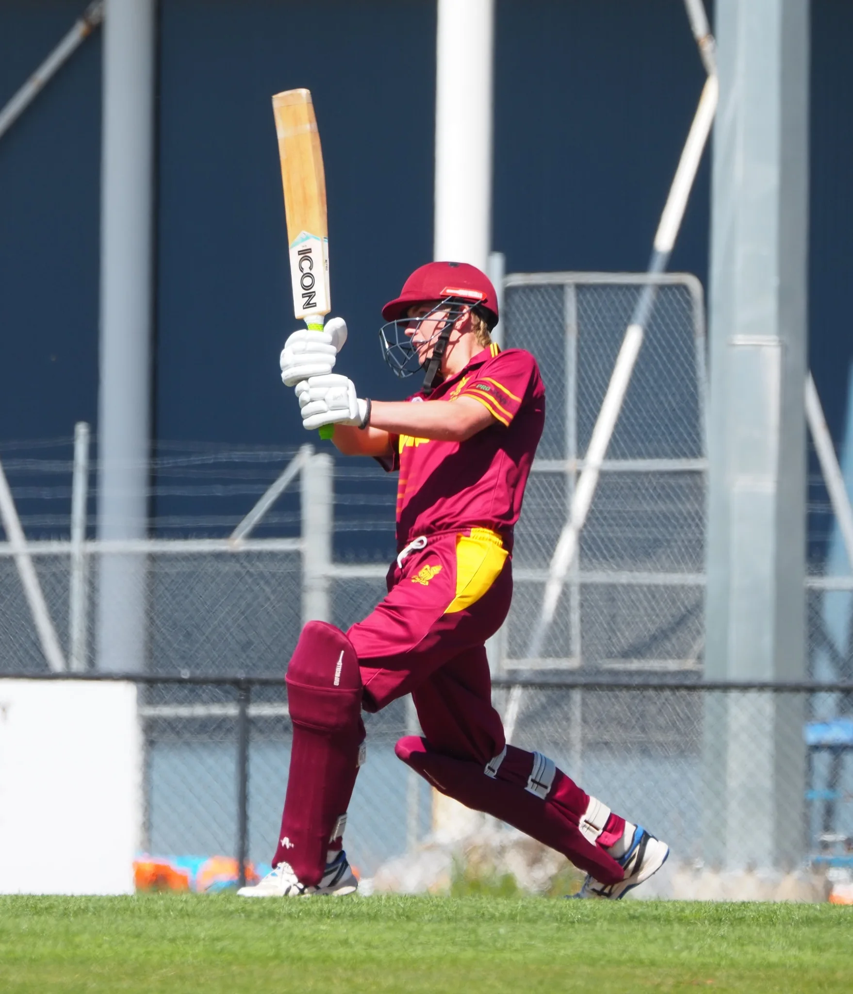 Young cricketer celebrating a successful hit.
